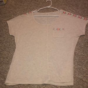 A shirt with colors on the sides of the arm